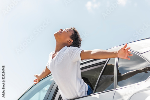 Happy kid travel by the car on summer season
