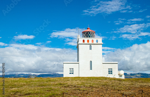 Dyrhólaey Lighthouse on island of Iceland on Europe. Popular tourist sight.