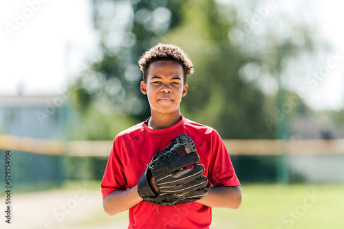 Photography portrait of child with glove and looking at camera playing baseball