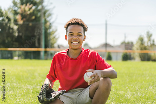 Canvas Print portrait of child with glove and looking at camera playing baseball