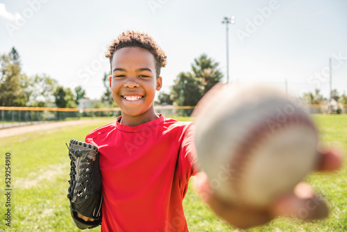Wall Mural portrait of child with glove and looking at camera playing baseball