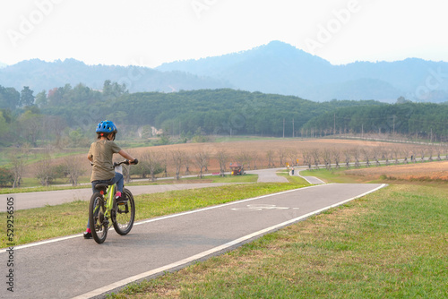 Asian girl is doing exercises on bicycles on the streets in the park.
