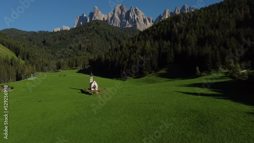 San Giovanni in Ranui St. John Church in Val di Funes Valley and Odle mountai range, Italian Dolomites. South Tyrol, Trentino Alto Adige, Italy aerial view.