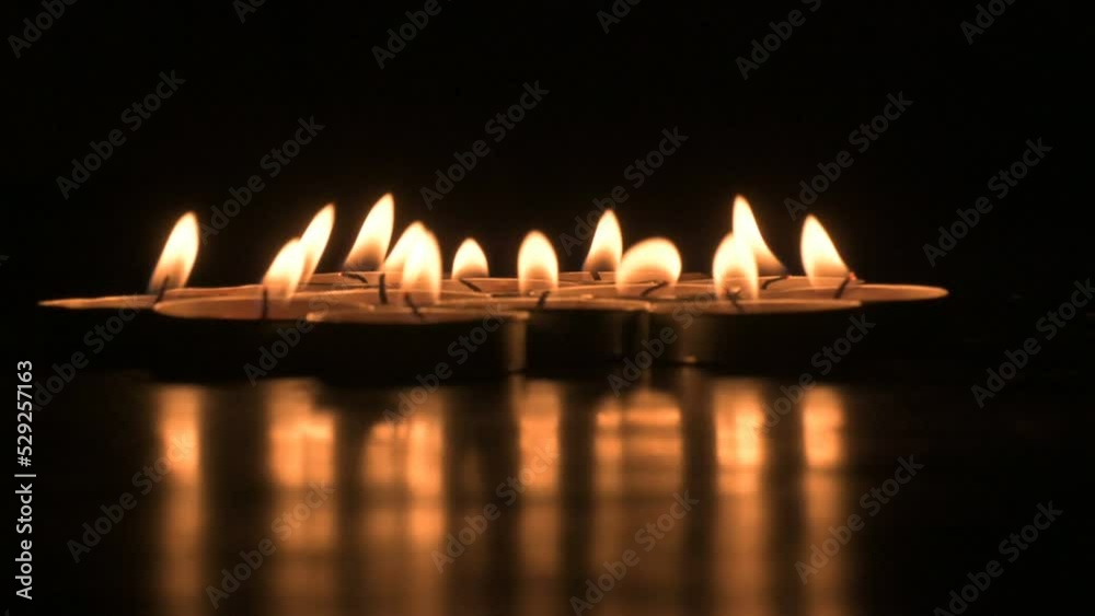 Very low angle view of Diwali diyas or candles. Deepawali lights at night. Dark background stock footage. Very low angle view of Diwali diyas or candles. Deepawali lights at night. Dark background stock footage.