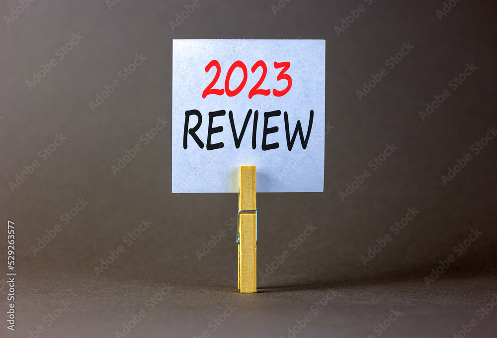 2023 Review symbol. White paper with words 2023 Review, clip on wooden ...