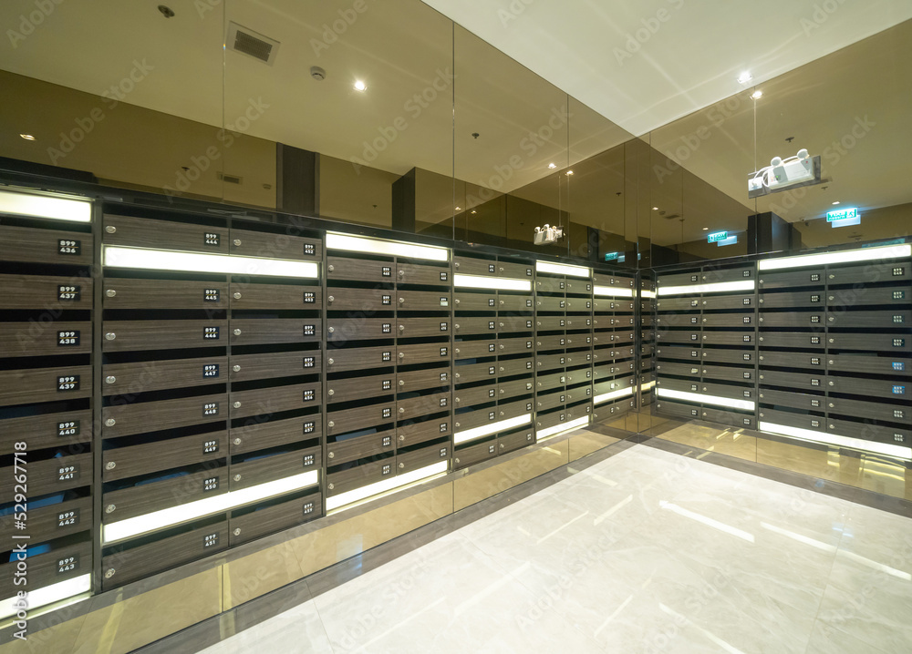 Postal mailbox with lockers in condominium, modern residential property. An indoor lockers facility service space. Interior design decoration.