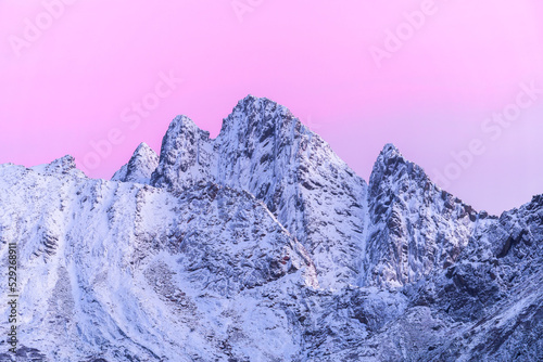 Mountain covered with snow at sunset in winter photo