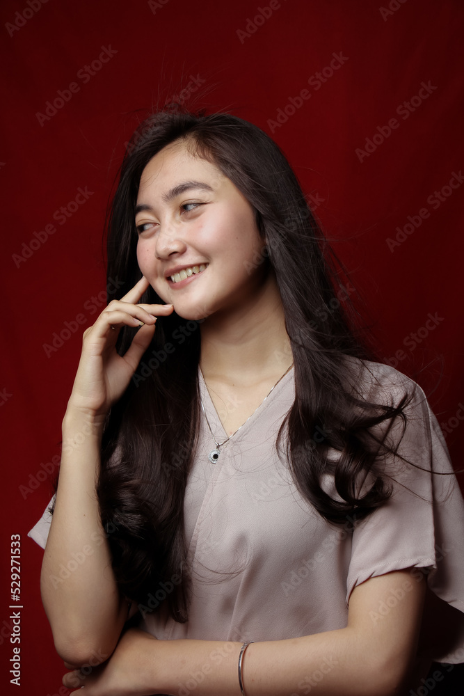 Asian woman taking photo on a red background. Happy Asian woman. Beautiful asian woman with long and straight hair. Asian woman taking photo on a red background. Happy Asian woman. Beautiful asian woman with long and straight hair.