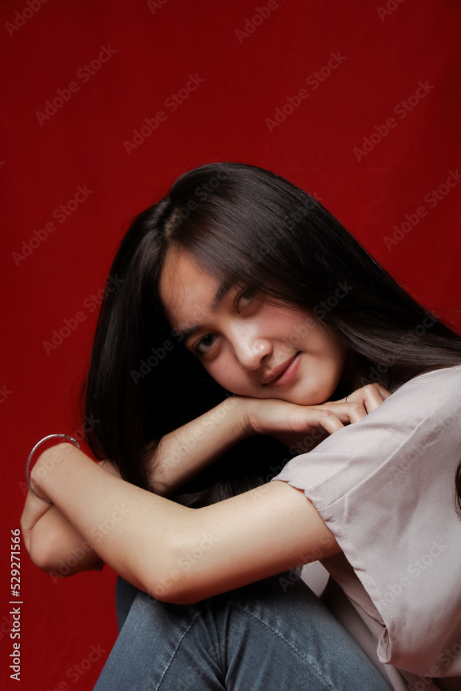 Asian woman taking photo on a red background. Happy Asian woman. Beautiful asian woman with long and straight hair. Asian woman taking photo on a red background. Happy Asian woman. Beautiful asian woman with long and straight hair.