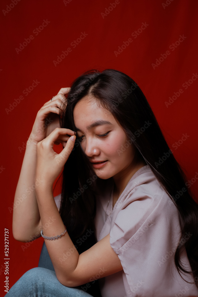 Asian woman taking photo on a red background. Happy Asian woman. Beautiful asian woman with long and straight hair. Asian woman taking photo on a red background. Happy Asian woman. Beautiful asian woman with long and straight hair.