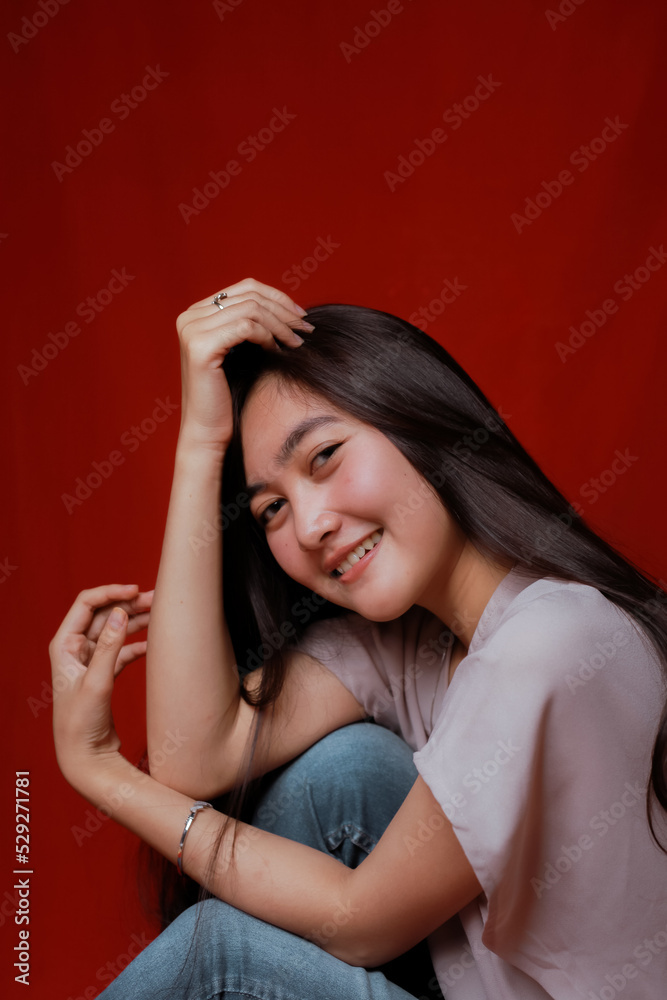 Asian woman taking photo on a red background. Happy Asian woman. Beautiful asian woman with long and straight hair. Asian woman taking photo on a red background. Happy Asian woman. Beautiful asian woman with long and straight hair.