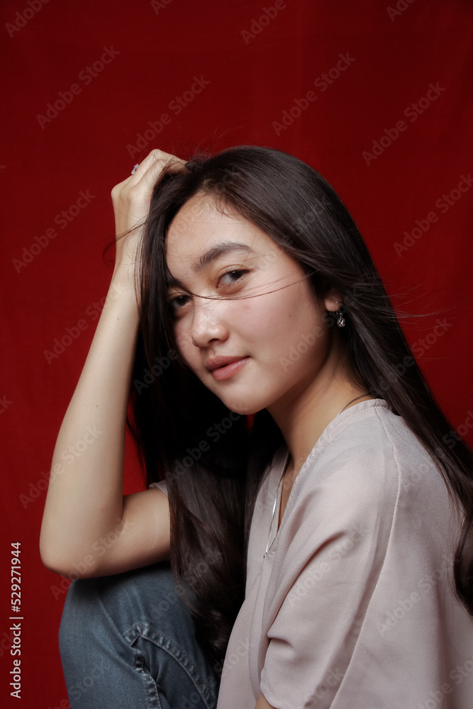 Asian woman taking photo on a red background. Happy Asian woman. Beautiful asian woman with long and straight hair. Asian woman taking photo on a red background. Happy Asian woman. Beautiful asian woman with long and straight hair.