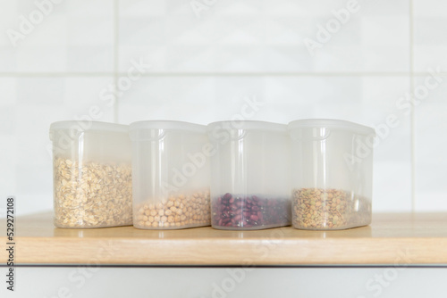 containers with cereals on a wooden table.