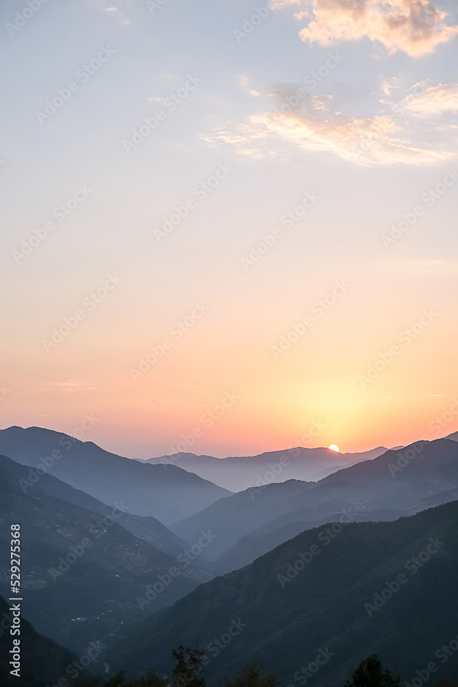 Smoky mountain sunset.Majestic autumn scenery of foggy valley at  mountain range at early morning sunrise. Beautiful tonal perspective wide angle panorama
