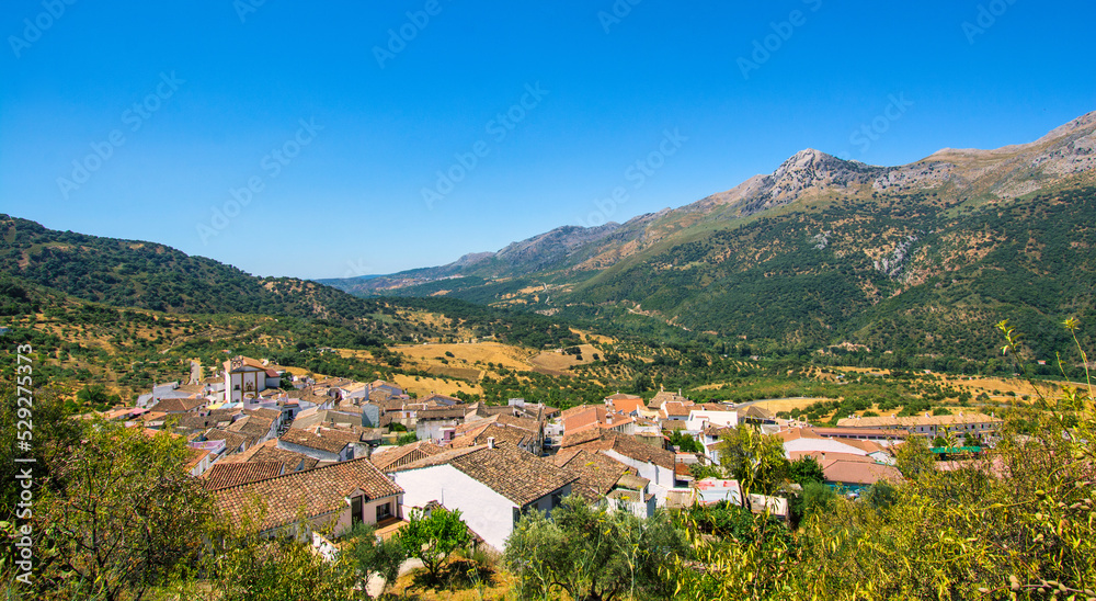Landscape of a small town in the Sierra de Málaga, Andalusia. Scenery of a small city surrounded by mountains. Spain, Europe