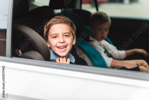 cute boy sitting in safety car seat