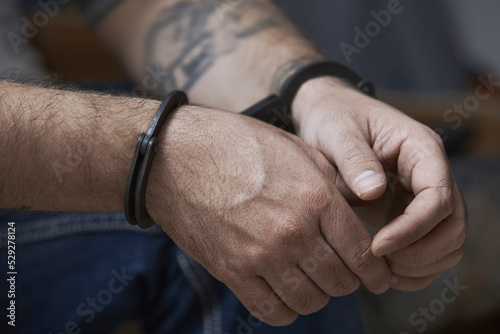 Cropped image of criminal in handcuffs