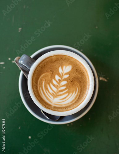 Overhead view of cappuccino served on wooden table photo