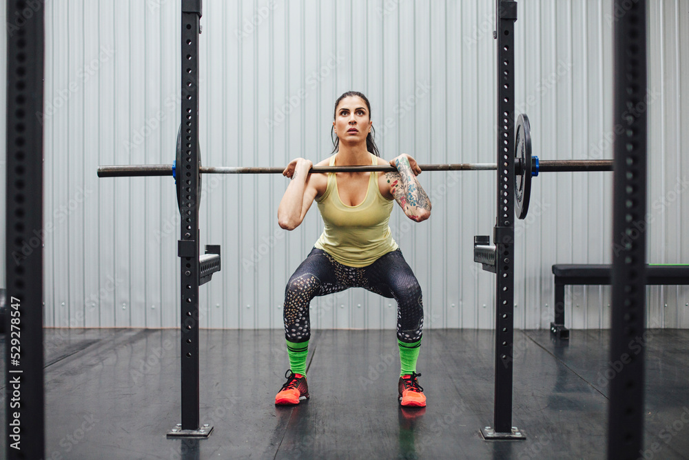 Confident woman lifting deadlift in gym Confident woman lifting deadlift in gym