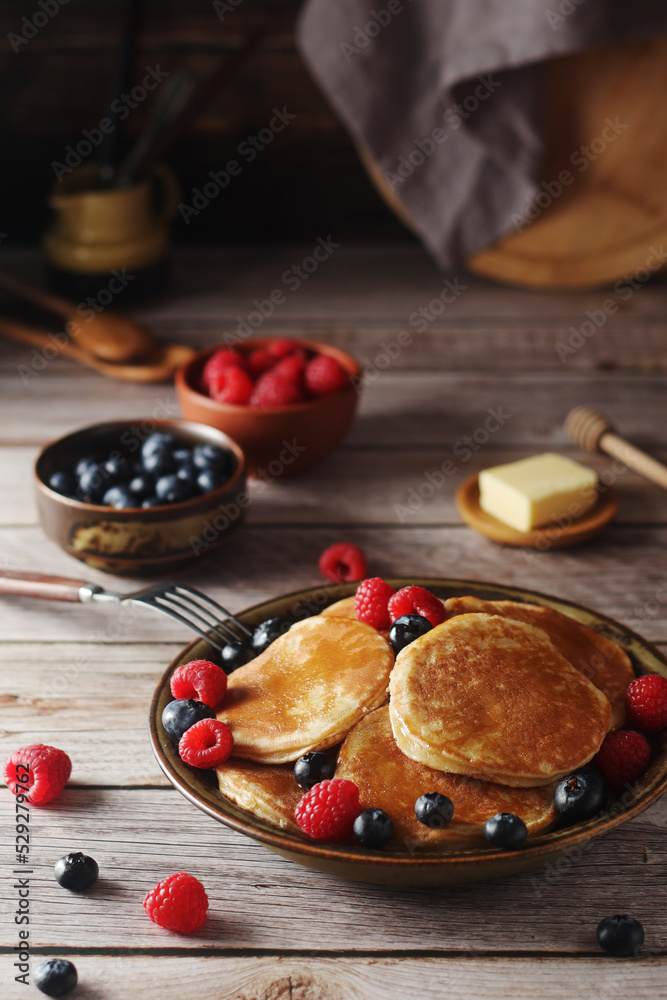 Pancakes with berries in rustic style