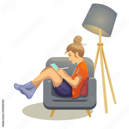 A girl draws on a tablet in a chair (ID: 529282302)