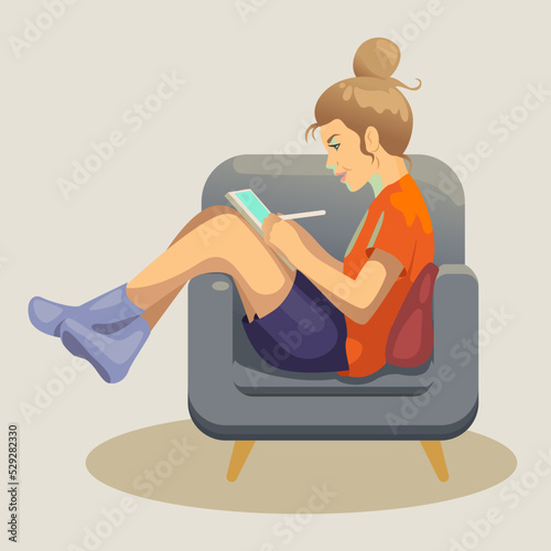 A girl draws on a tablet in a chair (ID: 529282330)
