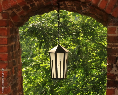 Needle's Eye medieval narrow gate in Sandomierz, lantern with needle and thread photo