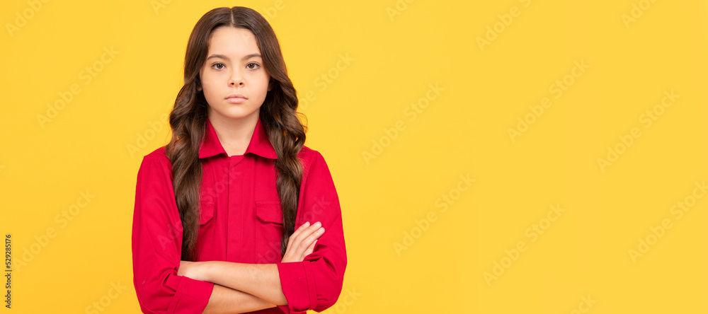 serious teen girl in red shirt. child has long curly hair. kid fashion and beauty. Child face, horizontal poster, teenager girl isolated portrait, banner with copy space. serious teen girl in red shirt. child has long curly hair. kid fashion and beauty. Child face, horizontal poster, teenager girl isolated portrait, banner with copy space.