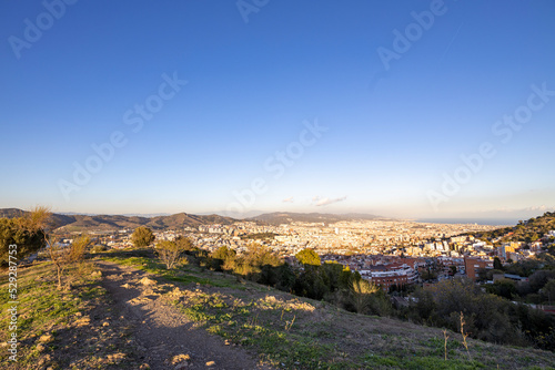 Barcelona skyline at sunny day. City landscape view from the mountain.