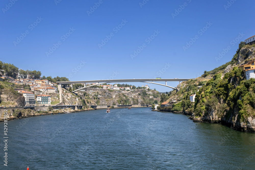 A scenic view of Douro River and Infante Dom Henrique Bridge in Porto