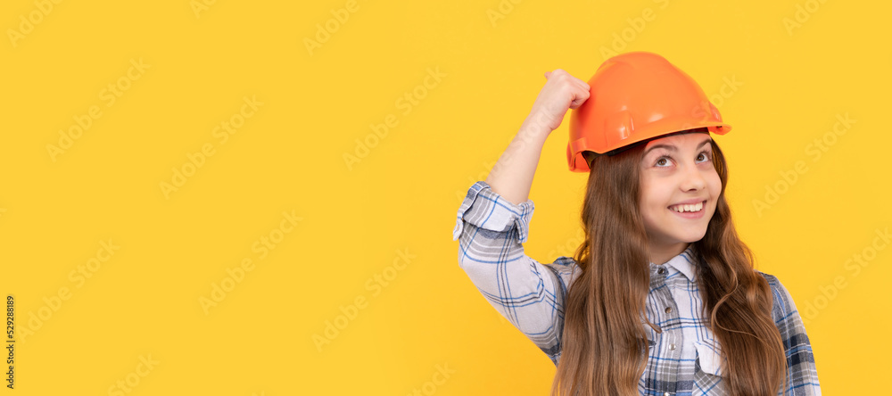 Engineer teenager girl. Funny teen girl in helmet and checkered shirt, build. Child in hard hat horizontal poster design. Banner header, copy space.