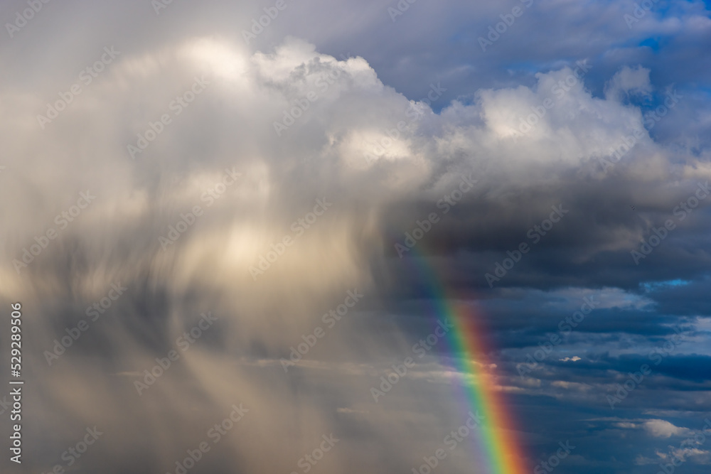 Rainbow colorful sunset on blue pink sky yellow clouds skyline. blue sky with white clouds - perfect for sky replacement	