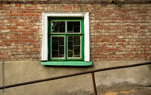 Old wooden window on the ground floor.