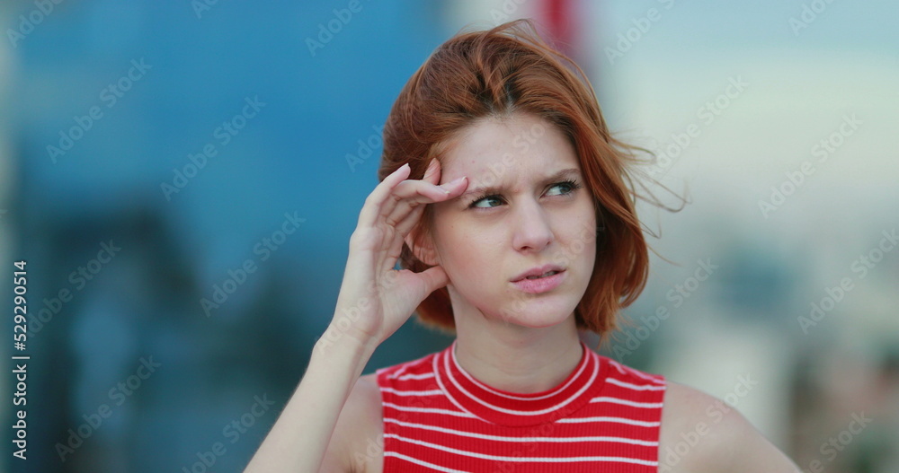 Young woman thinking deeply, looking for solutions, mental effort