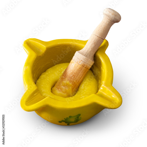 Foto Mortar and pestle with freshly made alioli sauce isolated on an empty backgrou