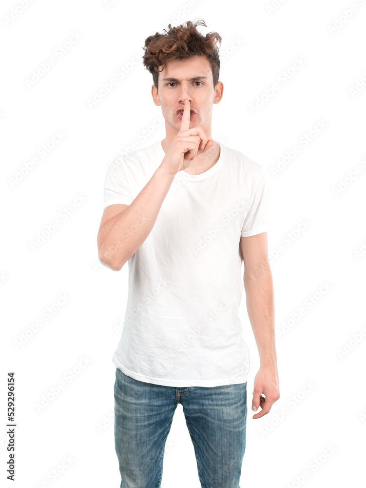 Serious young guy doing a gesture of silence Serious young guy doing a gesture of silence