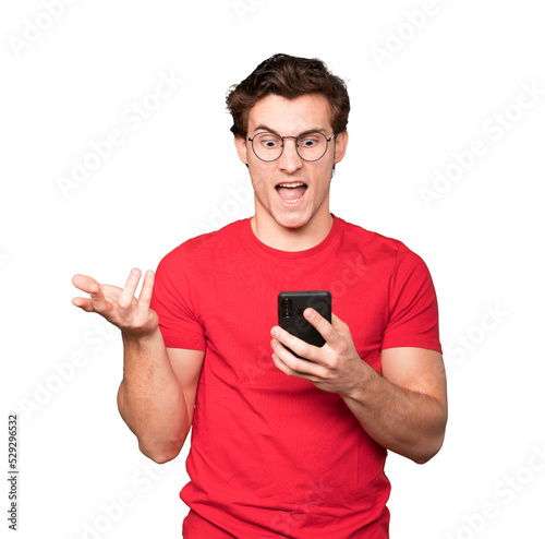 Angry young man using a mobile phone