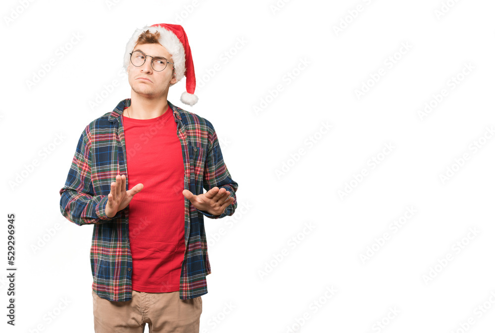Young man at Christmas doing gestures Young man at Christmas doing gestures