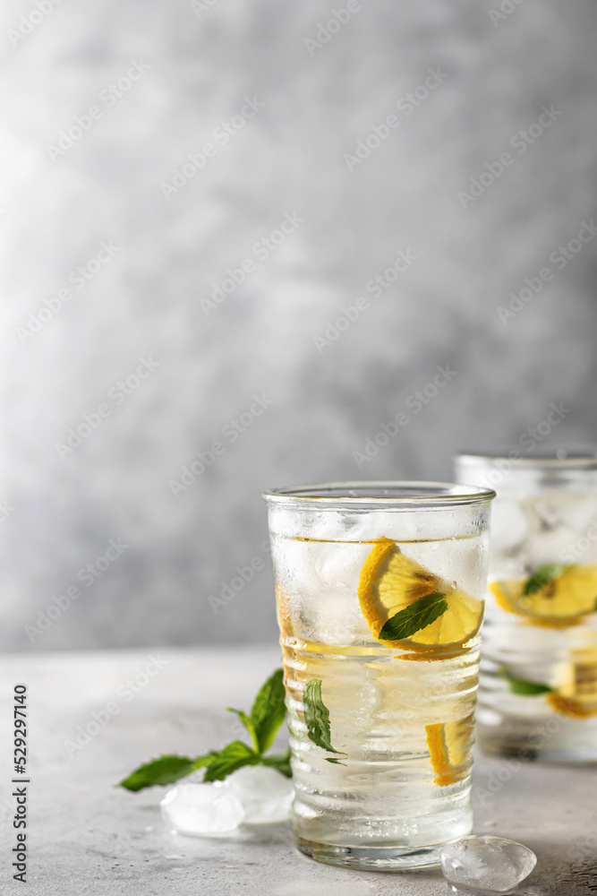 Iced refreshing detox water with lemon, mint in glasses. Homemade lemonade or cocktail. Space for text