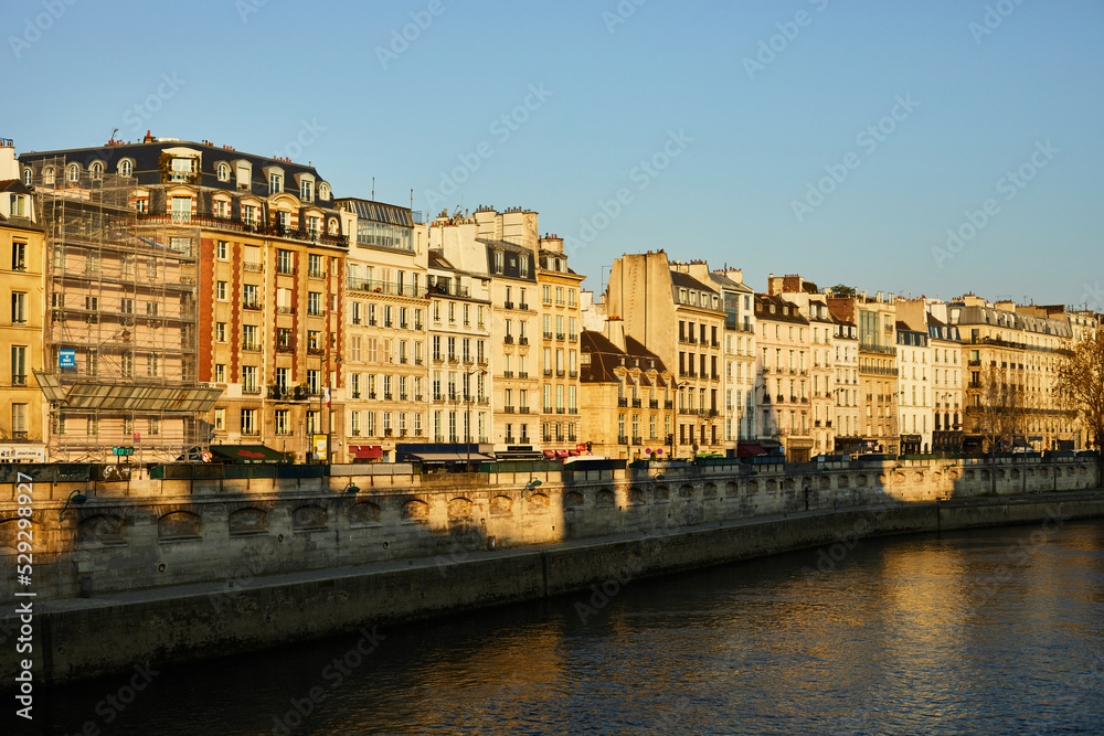 View on the bridge of the Seine, Haussmann buildings in morning Paris