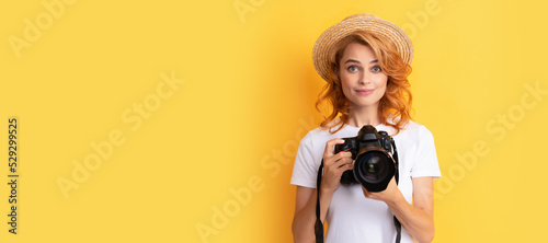 smiling redhead woman photographer with camera in straw hat making photo, photography. Woman isolated face portrait, banner with mock up copy space. photo