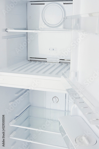 Close up of an empty refrigerator open. New white freezer.