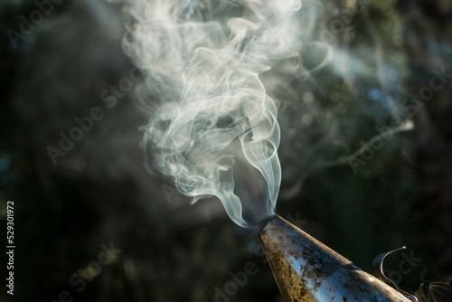 Close-up of smoke emitting from bee smoker used in apiculture photo