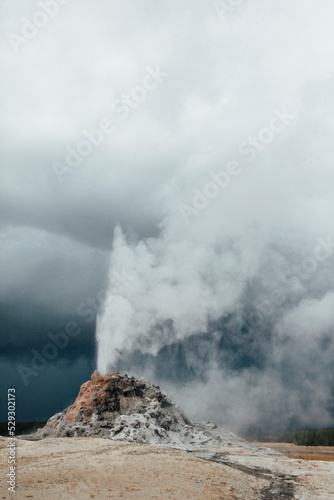 Scenic view of geezer against cloudy sky at Yellowstone national park