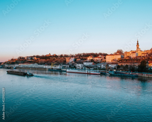 Boat in sea by buildings against sky