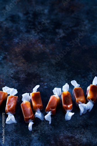 High angle view of caramel candies arranged on table photo