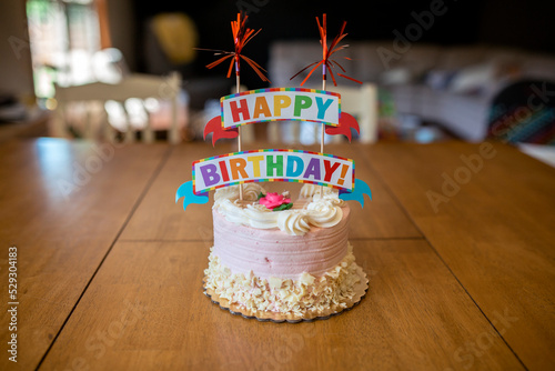 Birthday cake on table at home photo