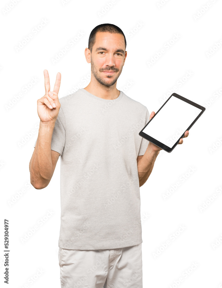 Young man doing gestures using a tablet Young man doing gestures using a tablet