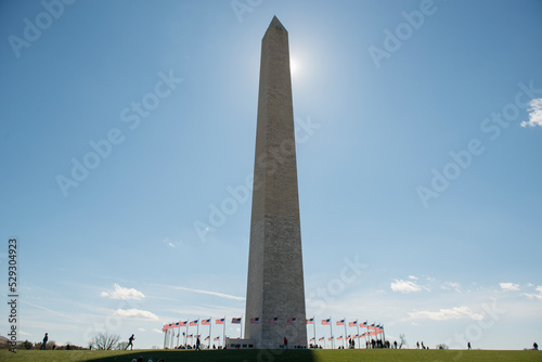 Low angle view of Washington Monument against sky during sunny day photo