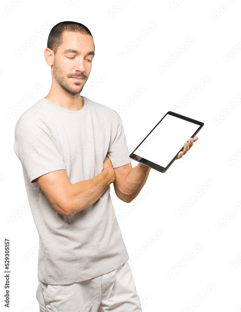 Young man doing gestures using a tablet Young man doing gestures using a tablet